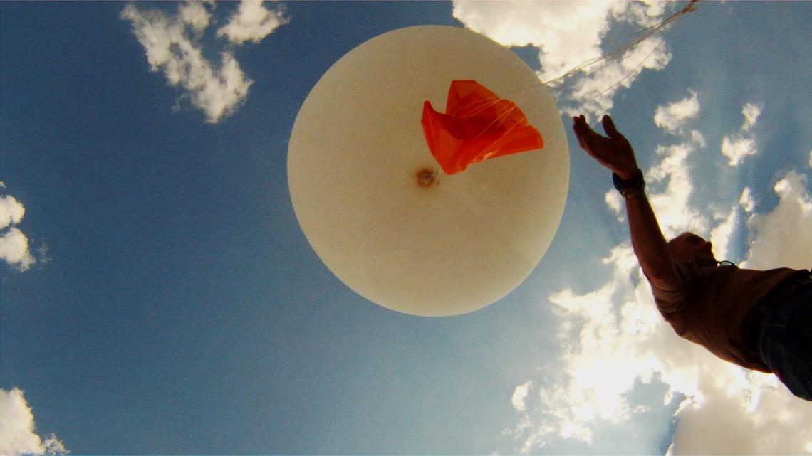 National Weather Service meteorologist Mic Sherwood releases a balloon to which is attached a weather instrument known as a radiosonde. 